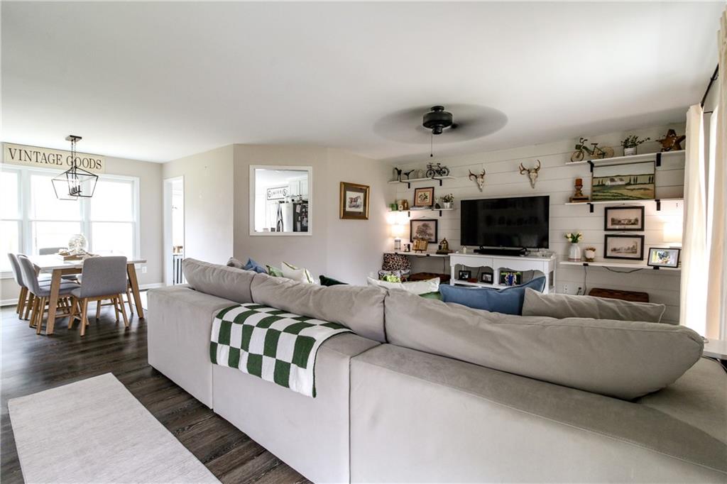1155 Orchid Way Canton, GA 30115 - Photo 2 of 40 a living room with furniture and a flat screen tv