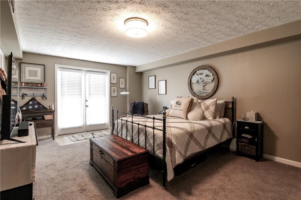 1155 Orchid Way Canton, GA 30115 - Photo 21 of 40 a bed room with a bed and a tv on wall
