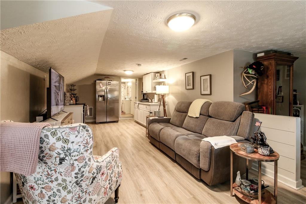 1155 Orchid Way Canton, GA 30115 - Photo 23 of 40 a living room with furniture a flat screen tv and a table
