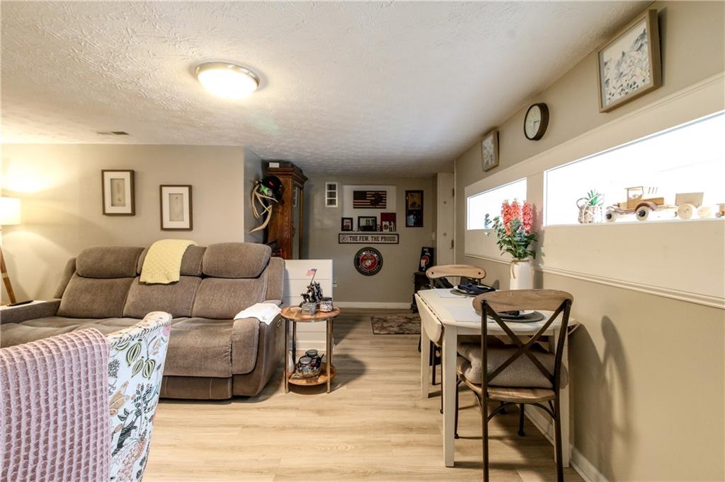 1155 Orchid Way Canton, GA 30115 - Photo 24 of 40 a living room with furniture and a large window
