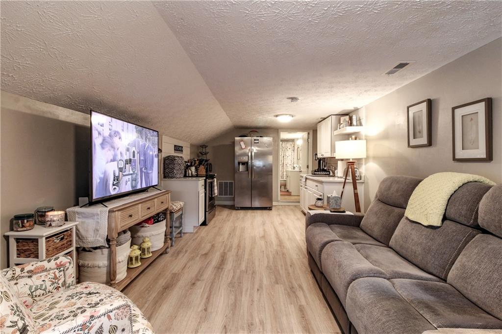 1155 Orchid Way Canton, GA 30115 - Photo 25 of 40 a living room with furniture and a flat screen tv