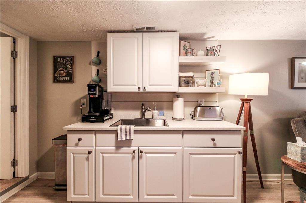 1155 Orchid Way Canton, GA 30115 - Photo 27 of 40 a kitchen with stainless steel appliances a sink and cabinets