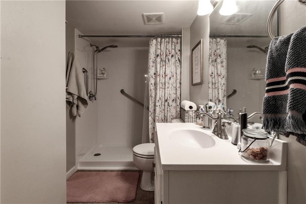 1155 Orchid Way Canton, GA 30115 - Photo 28 of 40 a bathroom with a sink toilet and shower