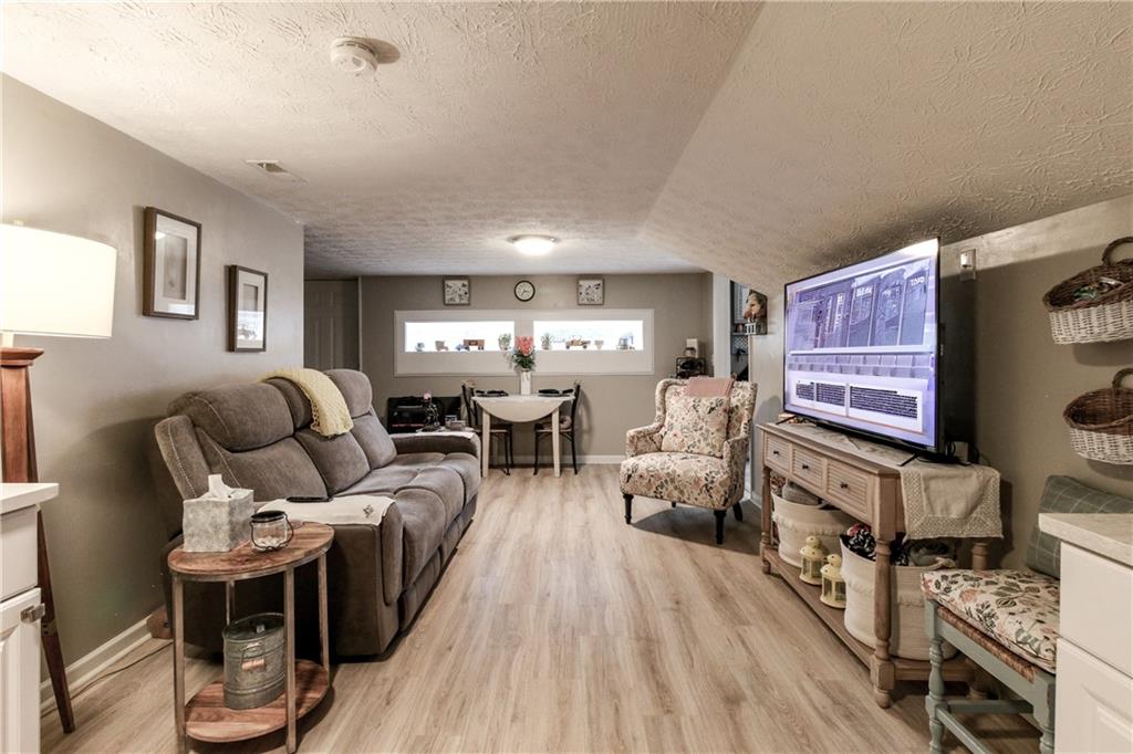 1155 Orchid Way Canton, GA 30115 - Photo 29 of 40 a living room with furniture and a wooden floor