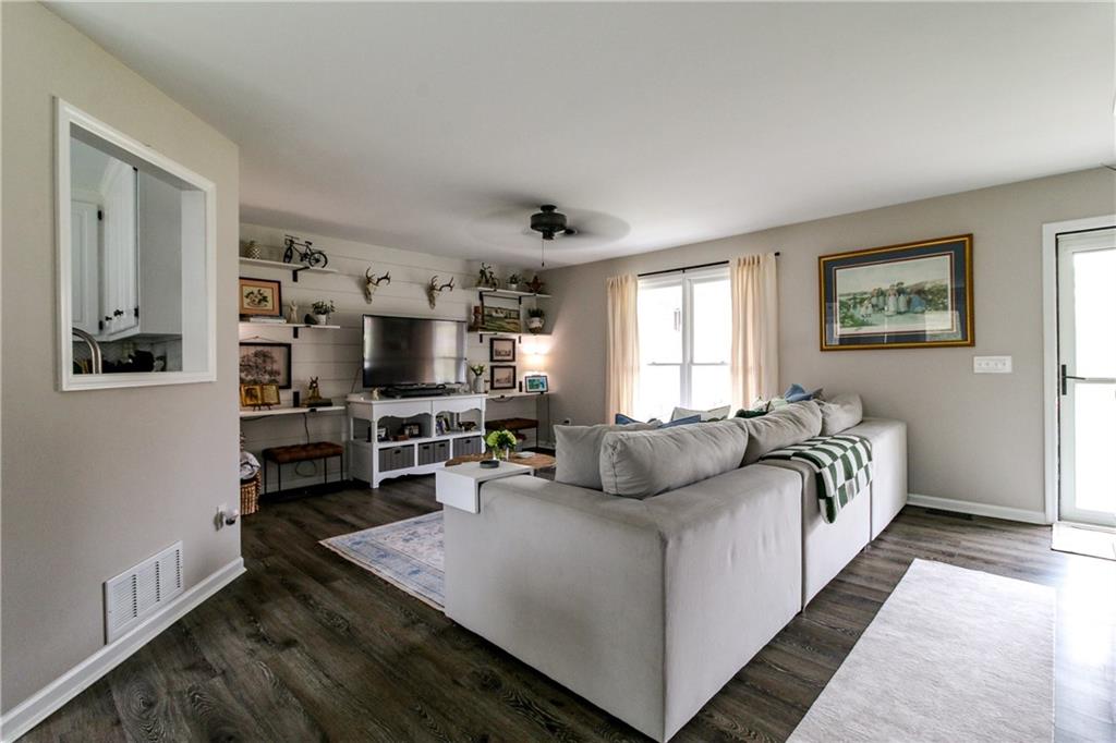 1155 Orchid Way Canton, GA 30115 - Photo 3 of 40 a living room with furniture and a flat screen tv