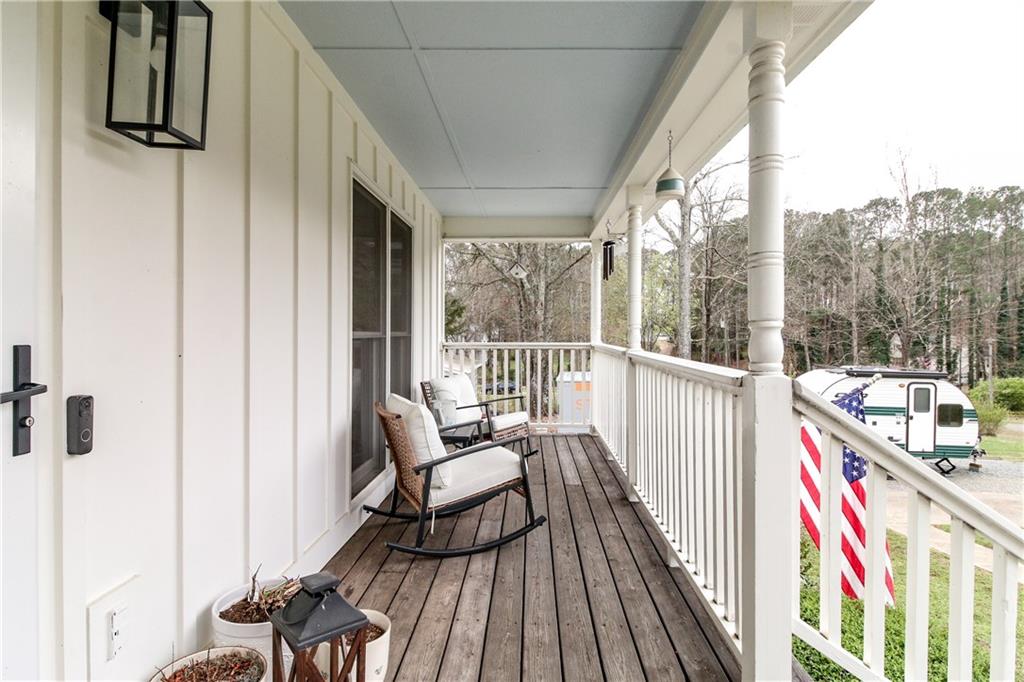 1155 Orchid Way Canton, GA 30115 - Photo 40 of 40 a balcony with wooden floor and outdoor seating