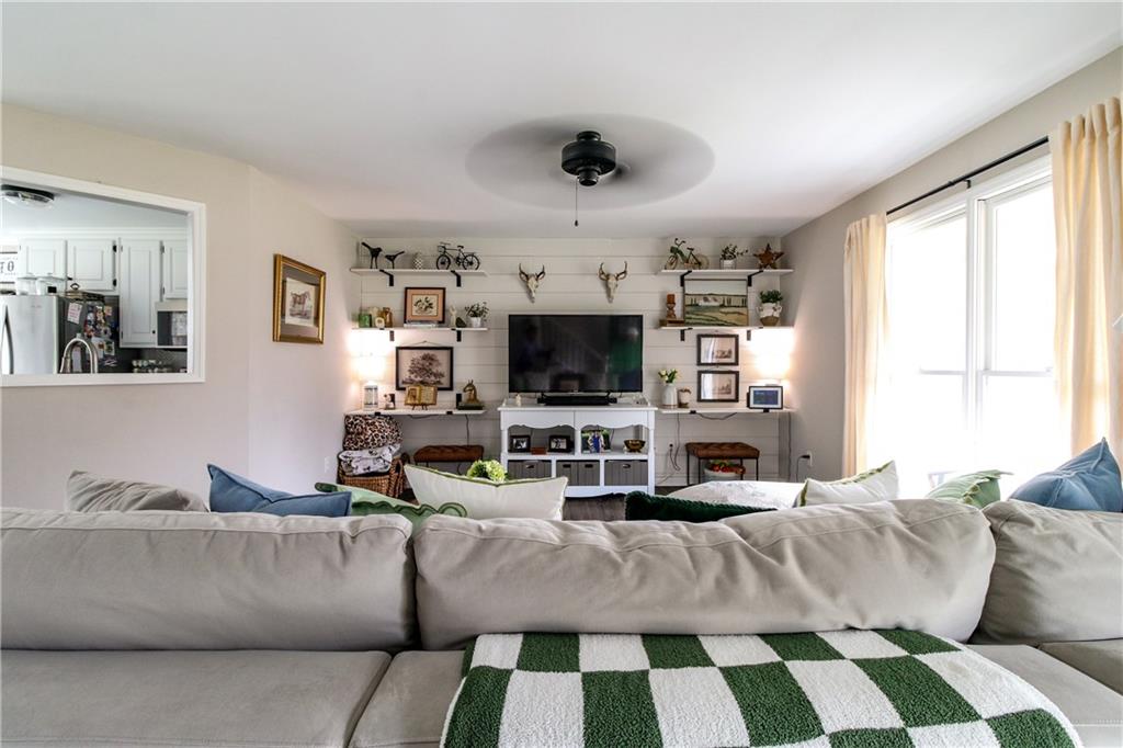 1155 Orchid Way Canton, GA 30115 - Photo 4 of 40 a living room with furniture and a flat screen tv