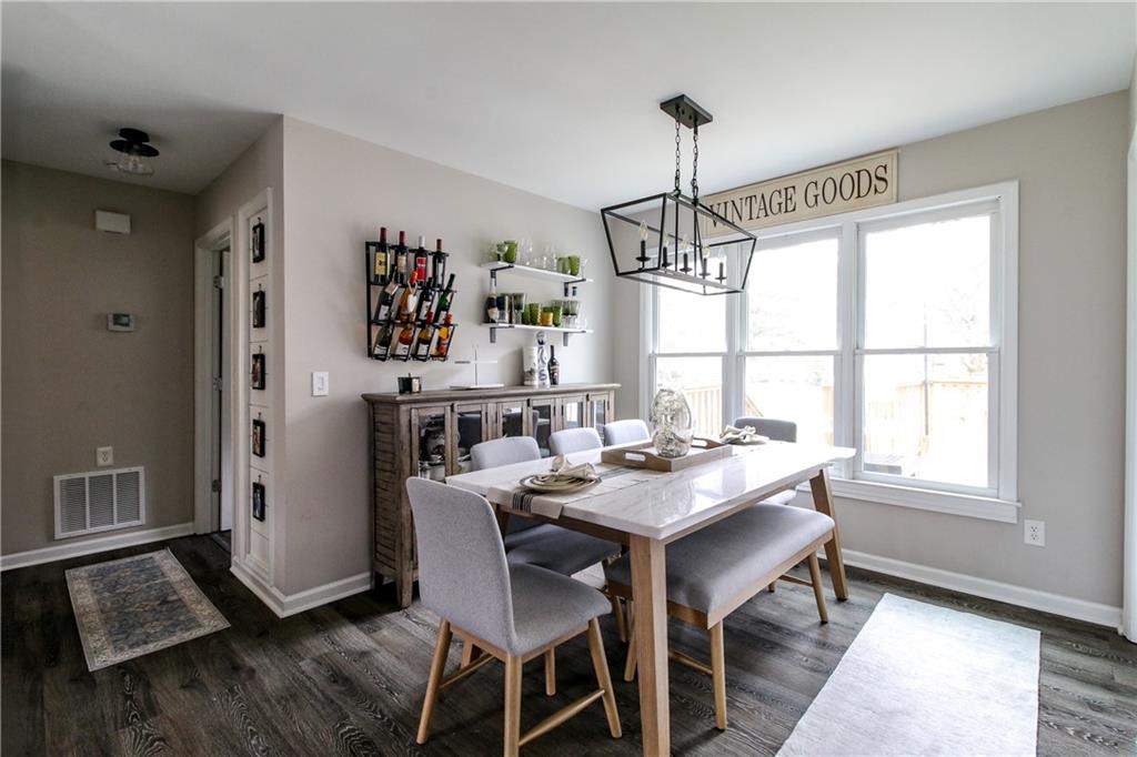 1155 Orchid Way Canton, GA 30115 - Photo 7 of 40 a view of a dining room with furniture window and wooden floor