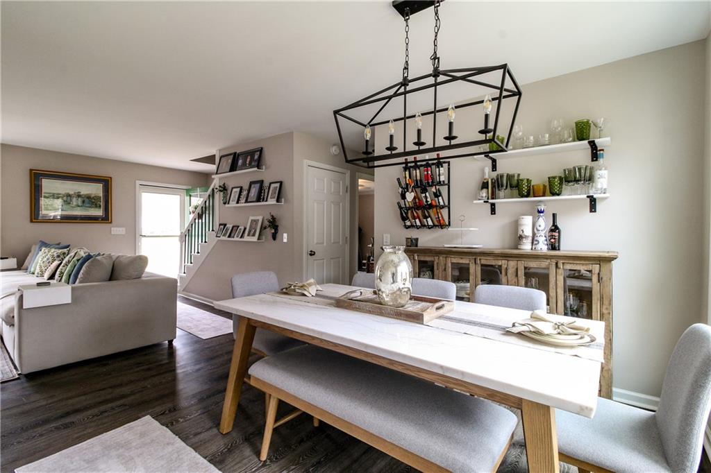 1155 Orchid Way Canton, GA 30115 - Photo 10 of 40 a living room with stainless steel appliances furniture a dining table and kitchen view
