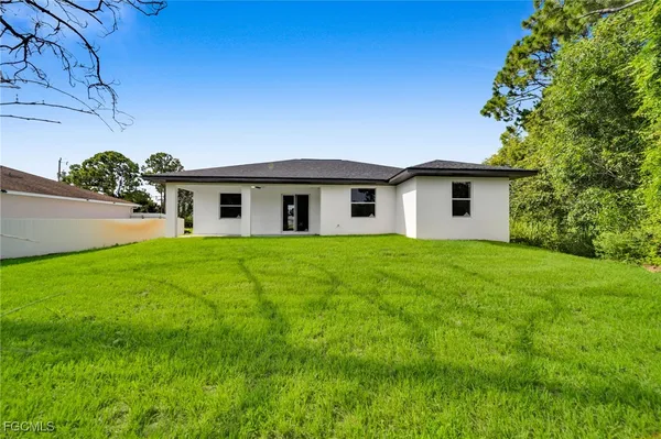 a view of house with backyard