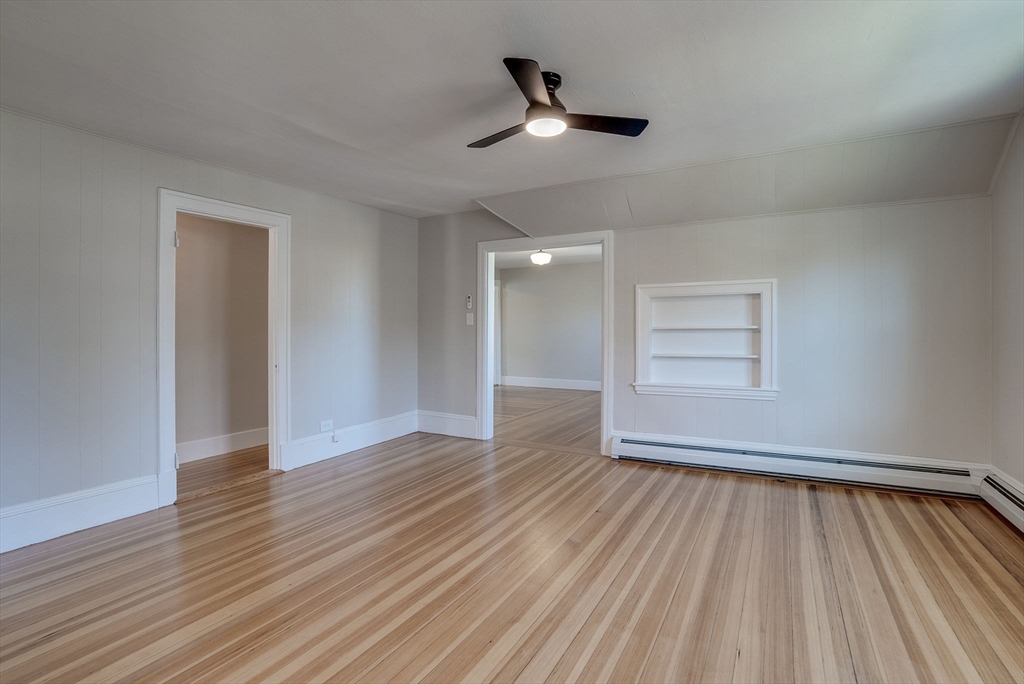 31 High Street, Unit 2 Beverly, MA 01915 - Photo 15 of 27 a view of an empty room with wooden floor and a window