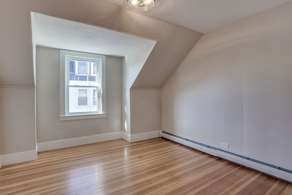 31 High Street, Unit 2 Beverly, MA 01915 - Photo 19 of 27 wooden floor in an empty room with a window
