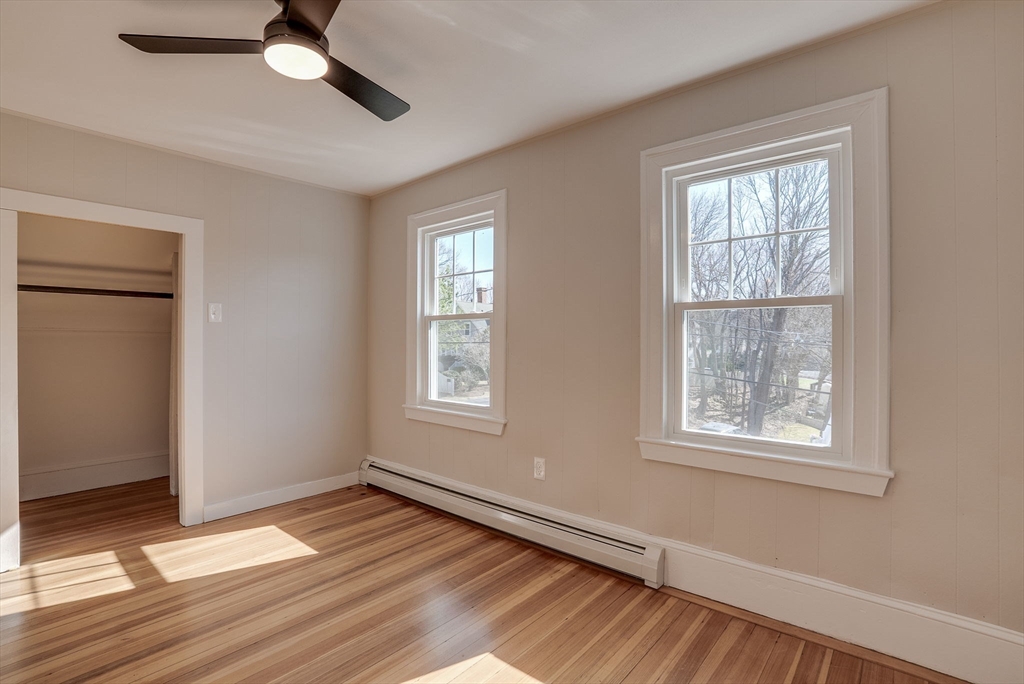 31 High Street, Unit 2 Beverly, MA 01915 - Photo 20 of 27 a view of an empty room with wooden floor and a window