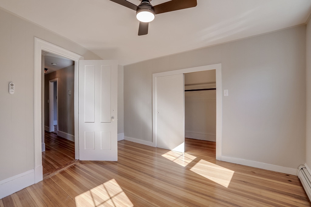 31 High Street, Unit 2 Beverly, MA 01915 - Photo 21 of 27 wooden floor in an empty room with a window