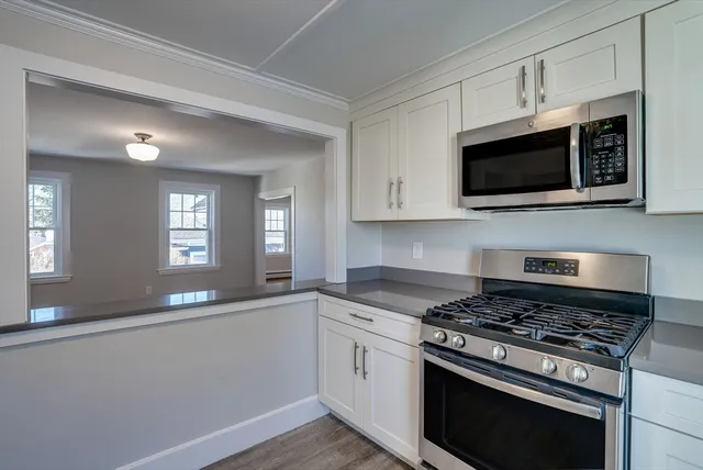 a kitchen with stainless steel appliances a stove a microwave and cabinets