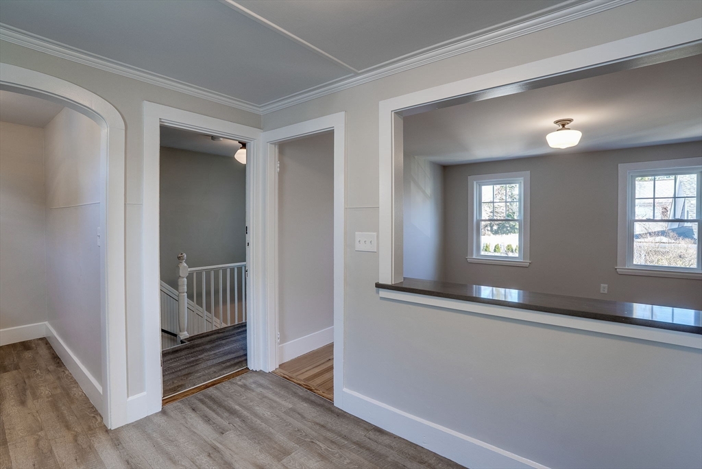 31 High Street, Unit 2 Beverly, MA 01915 - Photo 9 of 27 wooden floor in a hall with a window