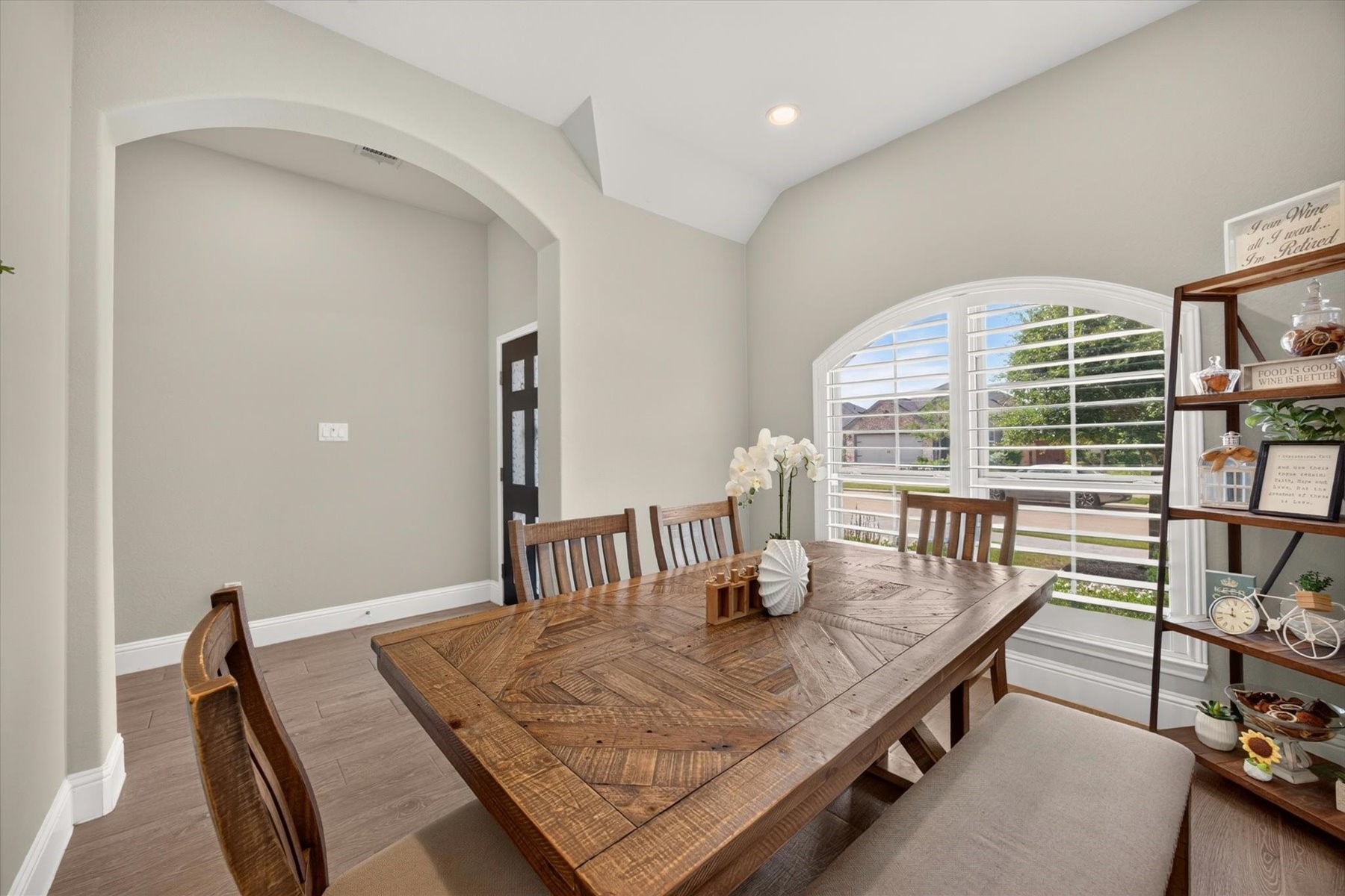 23026 Needle Grass Road Katy, TX 77493 - Photo 6 of 33 Bright dining room showcasing custom shutters and a beautiful arched window.