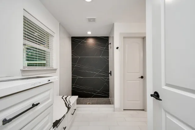 a bathroom with a shower and a window
