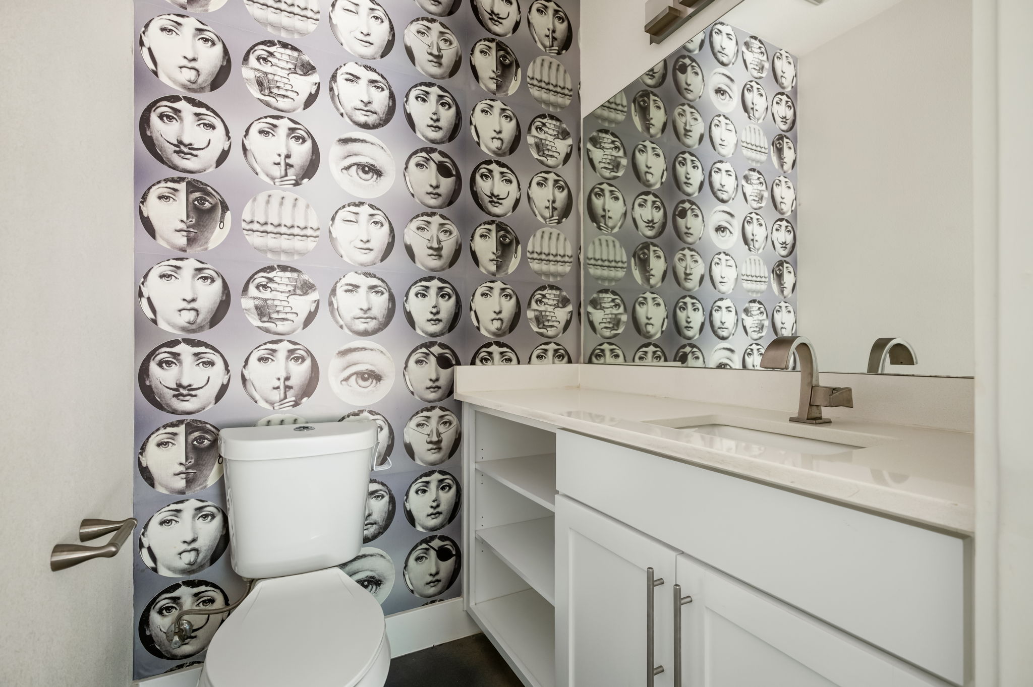 1902 Webberville Road, Unit B Austin, TX 78721 - Photo 15 of 39 Bold wallpaper enlivens this powder room with a sleek vanity and modern fixtures.