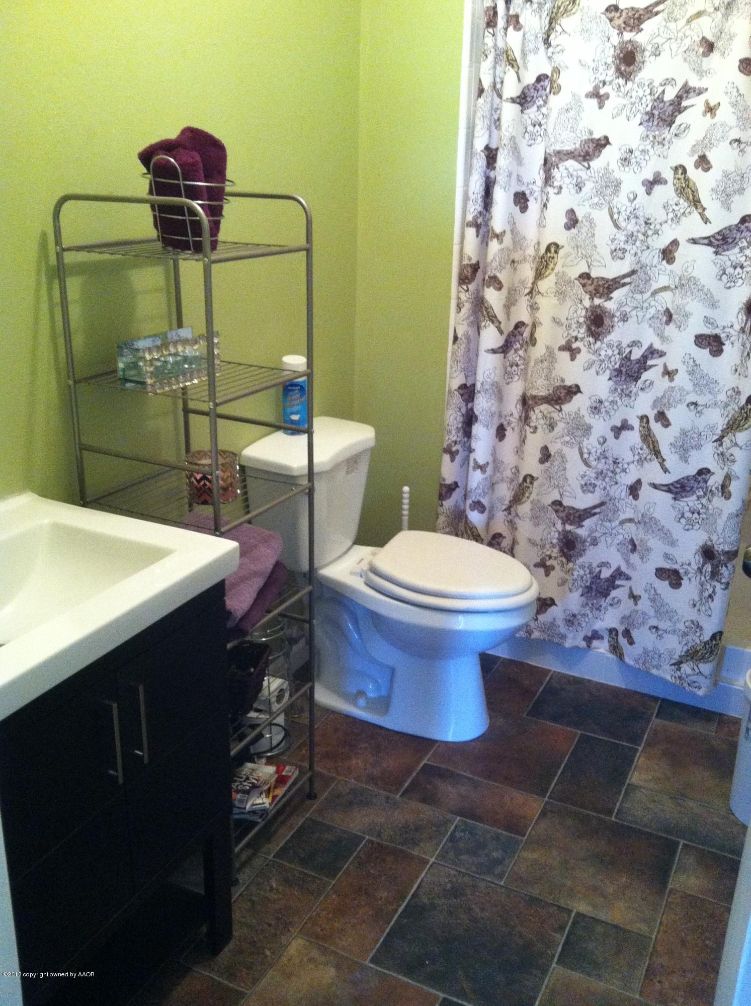 14176 Savannah Road Amarillo, TX 79118 - Photo 12 of 17 a bathroom with a sink toilet and shower