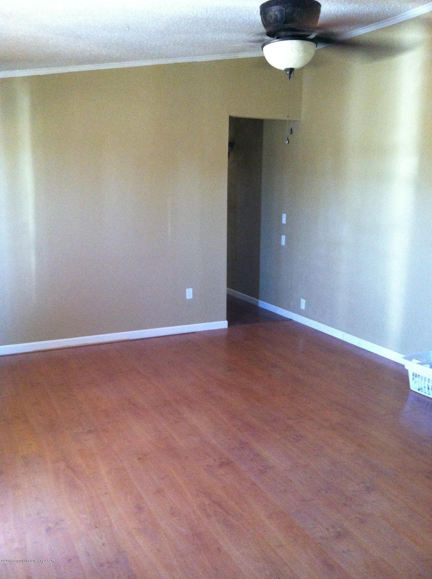 14176 Savannah Road Amarillo, TX 79118 - Photo 6 of 17 a view of an empty room with a chandelier fan