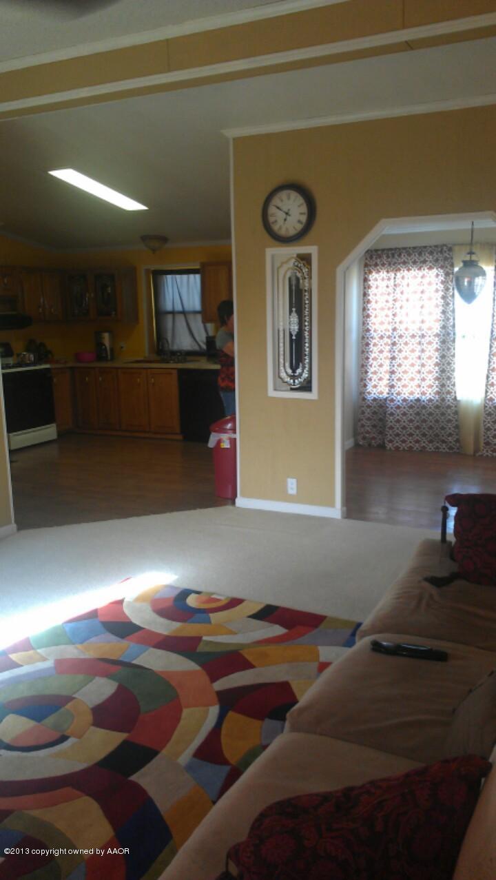 14176 Savannah Road Amarillo, TX 79118 - Photo 7 of 17 a living room with furniture and a fireplace