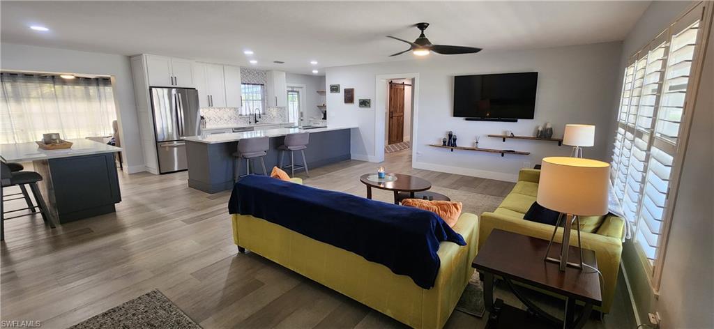 1280 Morningside Drive Naples, FL 34103 - Photo 2 of 35 a living room with furniture and a flat screen tv