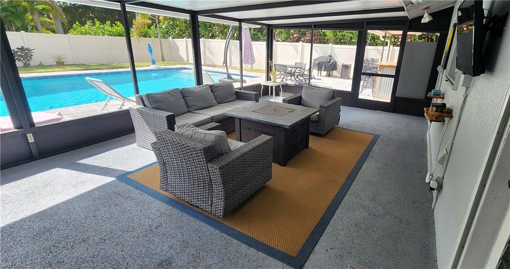 1280 Morningside Drive Naples, FL 34103 - Photo 22 of 35 a living room with furniture tv and a large window