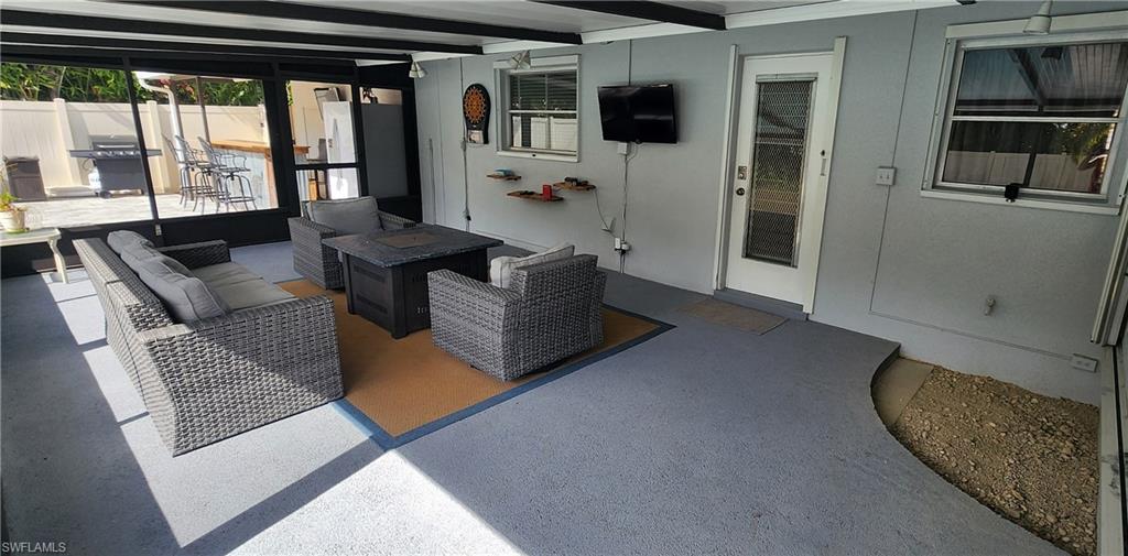 1280 Morningside Drive Naples, FL 34103 - Photo 24 of 35 a living room with furniture and a flat screen tv