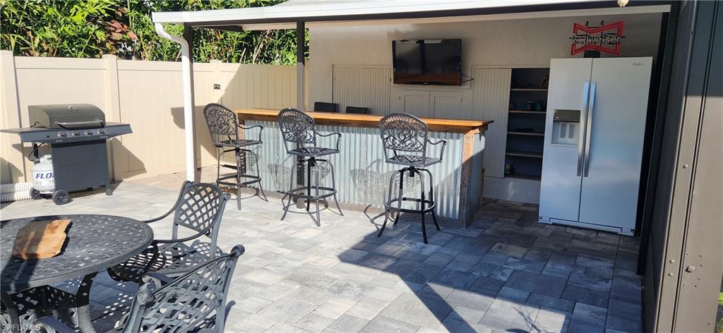 1280 Morningside Drive Naples, FL 34103 - Photo 30 of 35 a view of a dining room with furniture one side kitchen view and a wooden floor