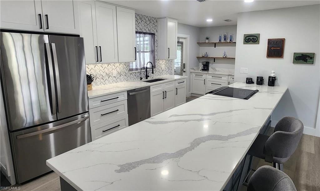 1280 Morningside Drive Naples, FL 34103 - Photo 6 of 35 a kitchen with stainless steel appliances a refrigerator sink and microwave