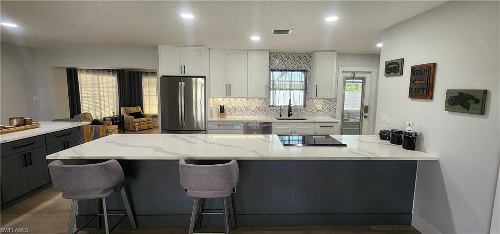 1280 Morningside Drive Naples, FL 34103 - Photo 10 of 35 a large kitchen with a table and chairs