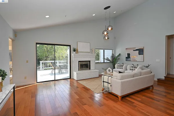 a kitchen with granite countertop cabinets a sink dining table and chairs