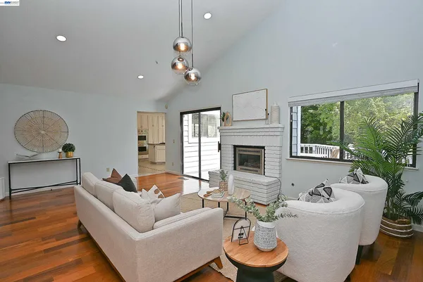 a kitchen with granite countertop a refrigerator and a stove top oven