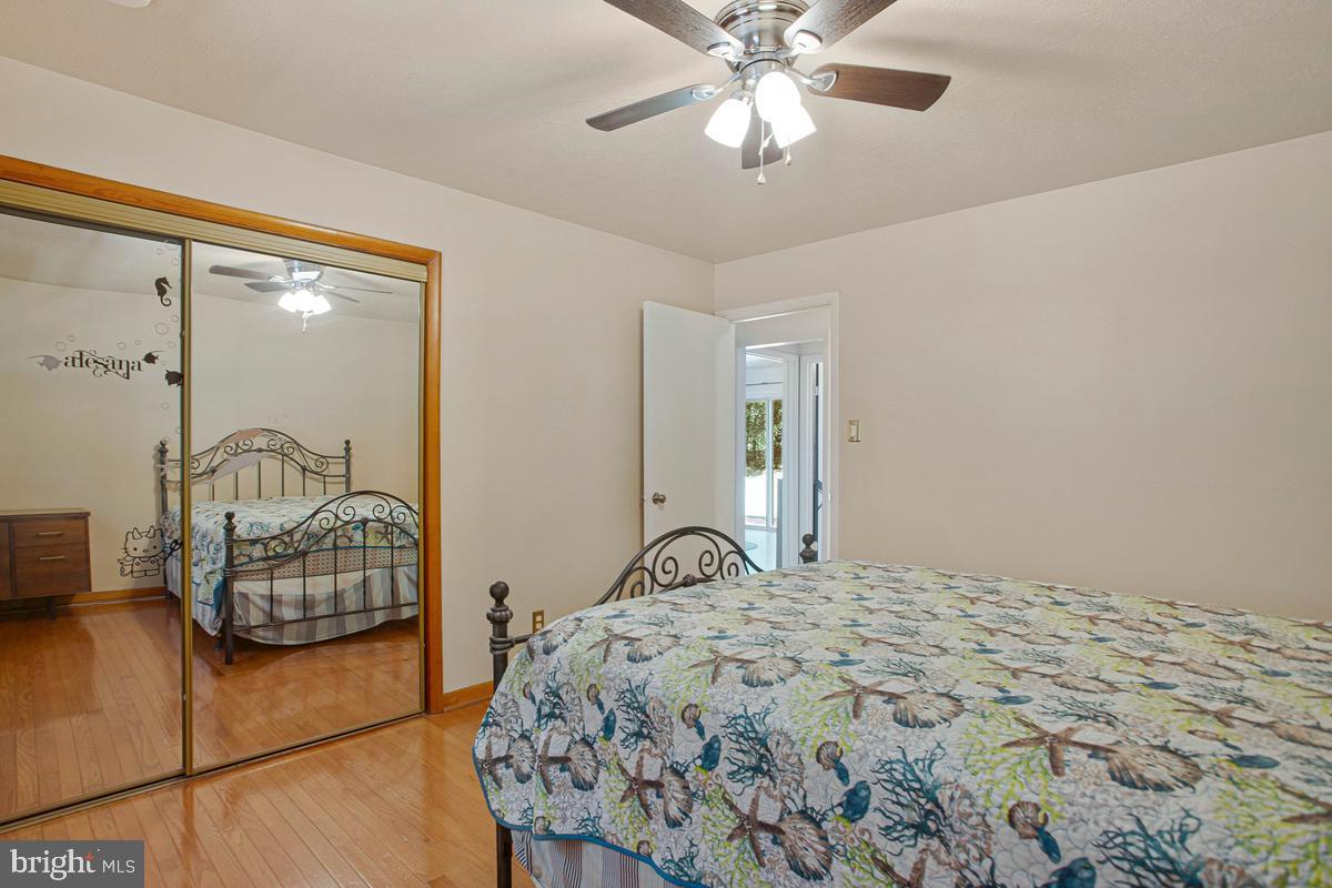 6600 Ashland Road La Plata, MD 20646 - Photo 16 of 40 a bedroom with a bed and a chandelier