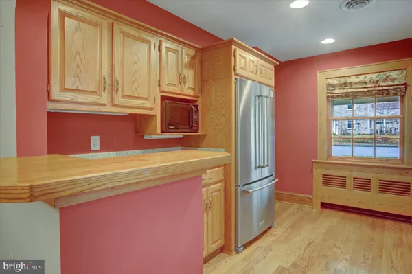 a view of a kitchen with a sink and dishwasher wooden floor