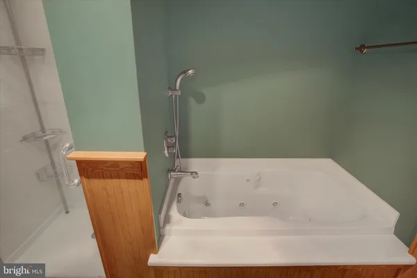 a view of a hallway with wooden floor and entryway
