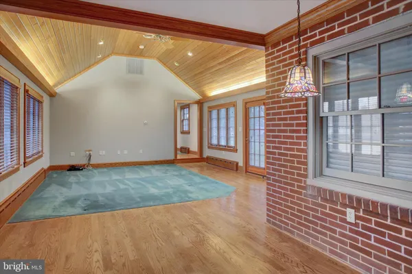 a view of a room with wooden floor