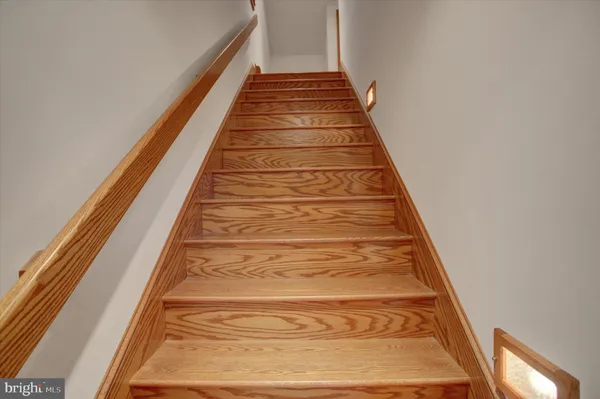 an empty room with wooden floor and a window