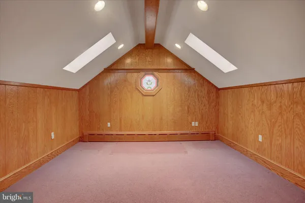 a front view of house with yard and trees around