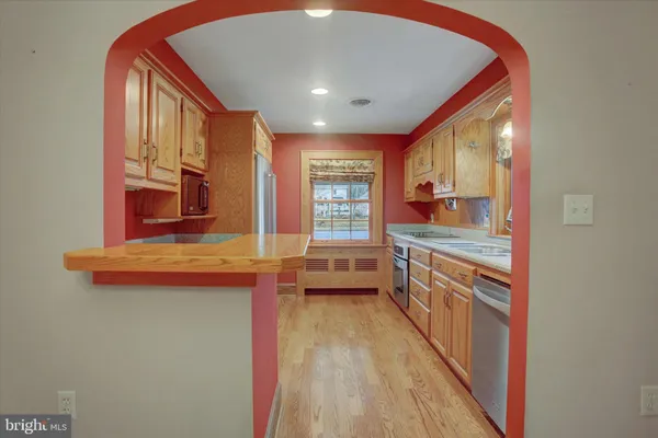 a kitchen with stainless steel appliances granite countertop a stove and a sink