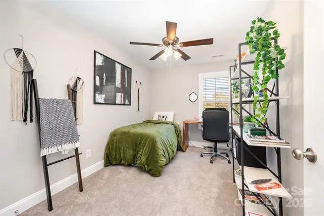 a bathroom with a granite countertop sink a toilet a mirror and shower curtain