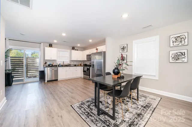 a living room with furniture and kitchen view