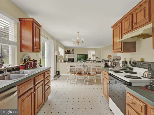 a kitchen with stainless steel appliances a sink stove and cabinets