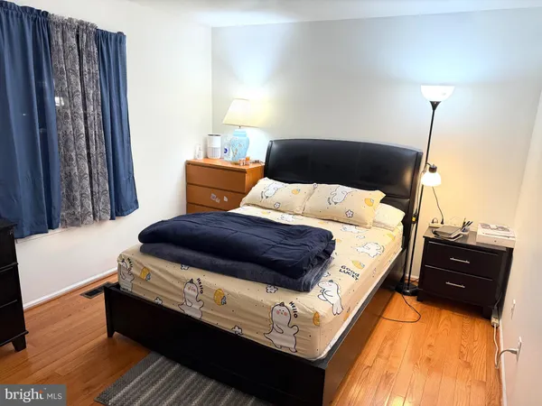 a bedroom with a bed window and a couch