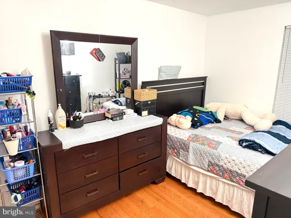 a bedroom with a bed and a flat tv screen on dresser