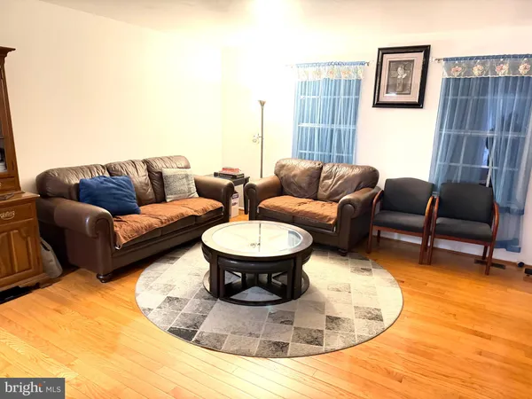a living room with furniture and a view of kitchen