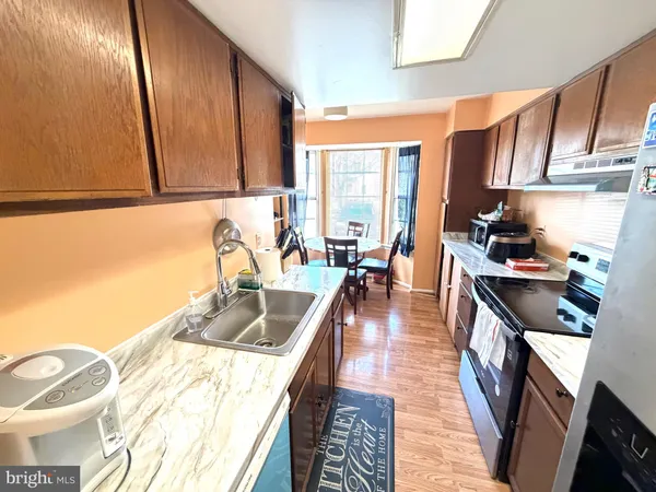 a kitchen with granite countertop a sink stove and cabinets