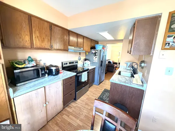 a kitchen with stainless steel appliances granite countertop a refrigerator sink and cabinets