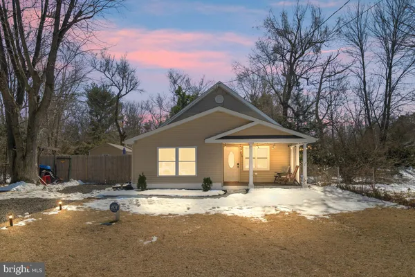 a view of a house with a yard covered in snow